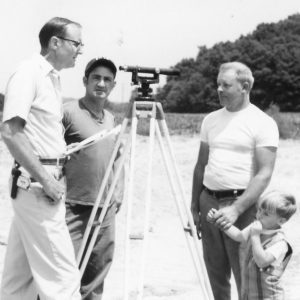 00-00-0000 Dean Swigart surveying-Photo includes 2 men and small boy-Photo by Robert Mills