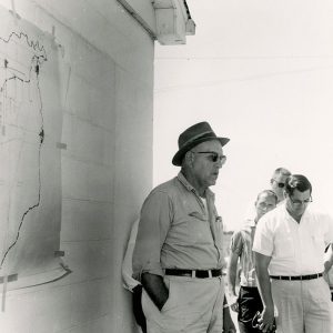 00-00-0000 Four unidentified men near building with map-website