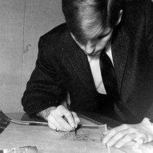 00-00-0000 Man sitting at desk writing on chart.Photo by Robert Mills