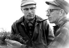 00-00-0000 Two men examingin packet of tree seedlings. Photo by Robert Mills