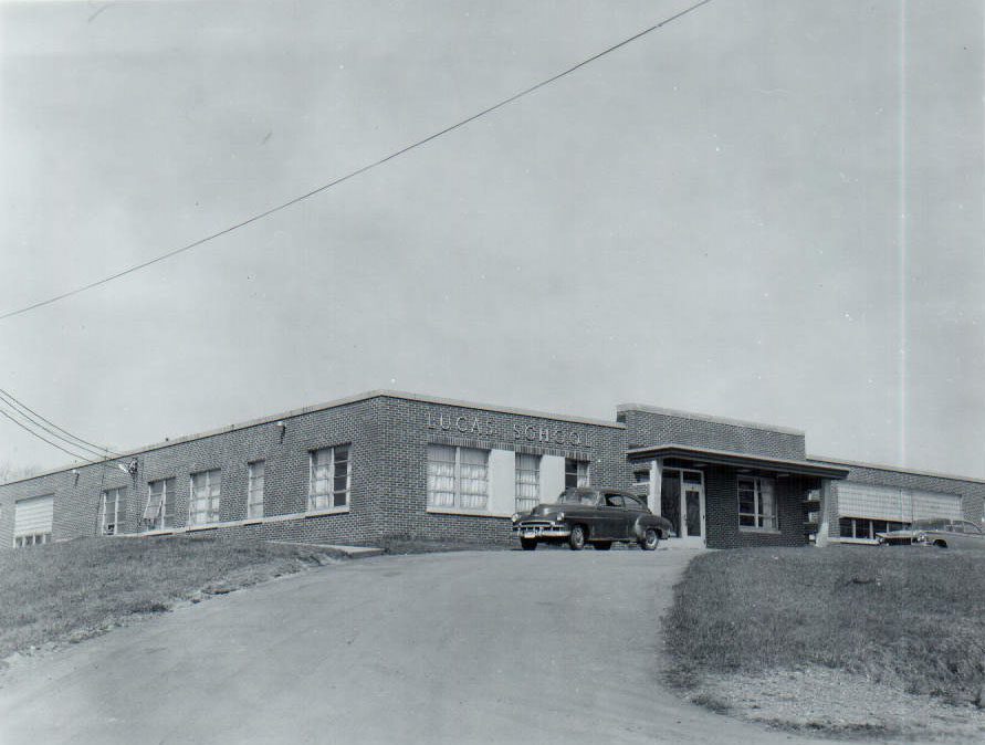 Lucas school building with car in front
p srcset=