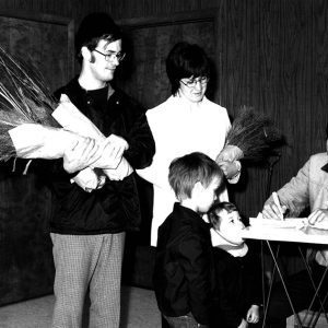 04-19-1975 Mr. and Mrs. Jerry Rondy & Rick & Brad pick up wildlife packets at the Ag Center from J. Van Loon-website