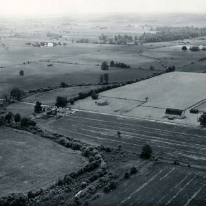 06-28-1962 View of Marsh Run as it crosses Sharp Rd. Looking southwest. Mike Mackey buildings are on left, J.Sharp buildings are in the right.-website