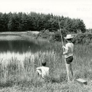 07-15-1975 Edward Stewart & Todd Mills fishing for bass & bluegill on the 4-H camp property at Rural Life Center