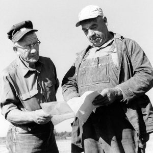 08-10-1972 William Enderby (Farm owner) & William Myers (contracter) examine the SCS plan for a pond under construction-website