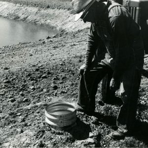 08-30-1968 Doyle McCarron at water intake for fire truck as build on new farm pond-website