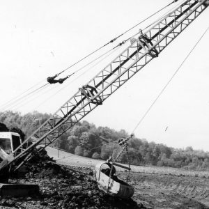 Crane with bucket removing dirt .Photo by Robert Mills