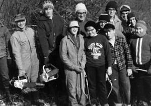 Group of boys posing with chain saws and pruning saws. Photo by Robert Mills