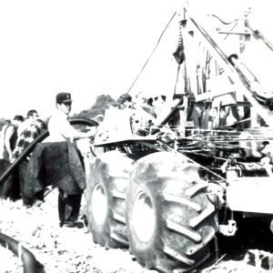 Group of men at dirch digging machine as tile feeds in. Photo by Robert Mills