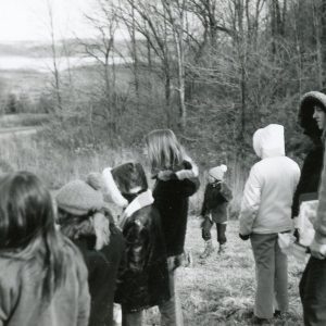 Group of students with man standing on hillside. Photo by Robert Mills