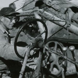 Man at wheel of a machine. Photo by Robert Mills