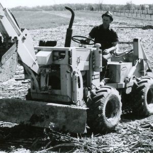 Man driving back hoe. Photo by Robert Mills