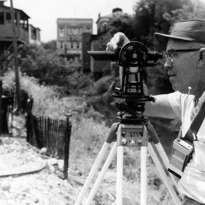 Man looking into survey instrument .Photo by Robert Mills
