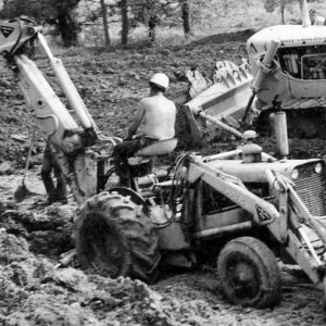 Man on back hoe digging .Photo by Robert Mills