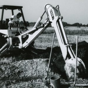 Man operating back hole digging a trench. Photo by Robert Mills