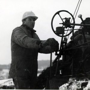 Man operting controls of a machine. Photo by Robert Mills