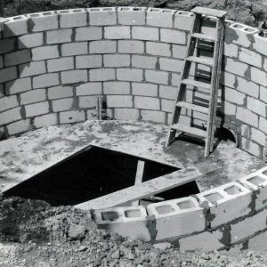 Man viewing a holding tank under construction. Photo by Robert Mills