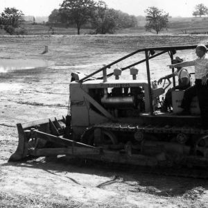 S.M.Donohueband Frank Eberl on huge tractor machine with plow attached .Photo by Robert Mills
