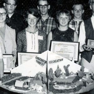 Students displaying certificates in front of exhibit at Science Fair (Photo by Robert Mills)