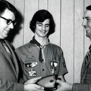 Troop121. Scout master Thos.Callahan is receiving plaque from Thomas Kranz Dist Chmn for Outstanding Service to Forestry. Looking on is Sr Patrol leader Guy Guzzo-0001