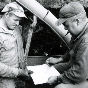 Two men studying a blueprint. Photo by Robert Mills