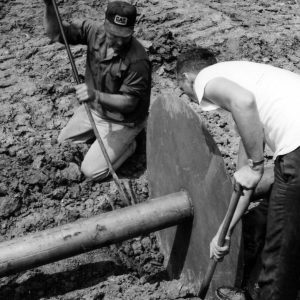 Two men working on a pipe connection .Photo by Robert Mills