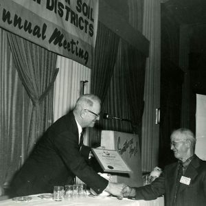 Unidentified man making a presentation at an annual meeting-website