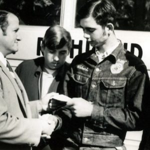William Wareham presenting check to 3 students. Photo by Robert Mills