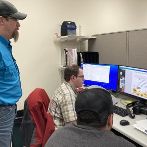Conrad Logan working with Herrold, Dan and Keller, Jordan RichlandSWCD Technicians with a workshop flyer