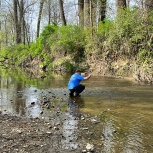 Matt, SWCD Technician, Taking Downstream Water Sample for Agriculture Pollution Abatement Program. Water Sample April 4, 2023