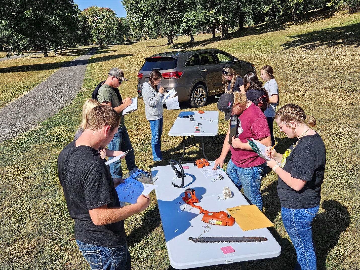 Students gathered around the equipment identification table.