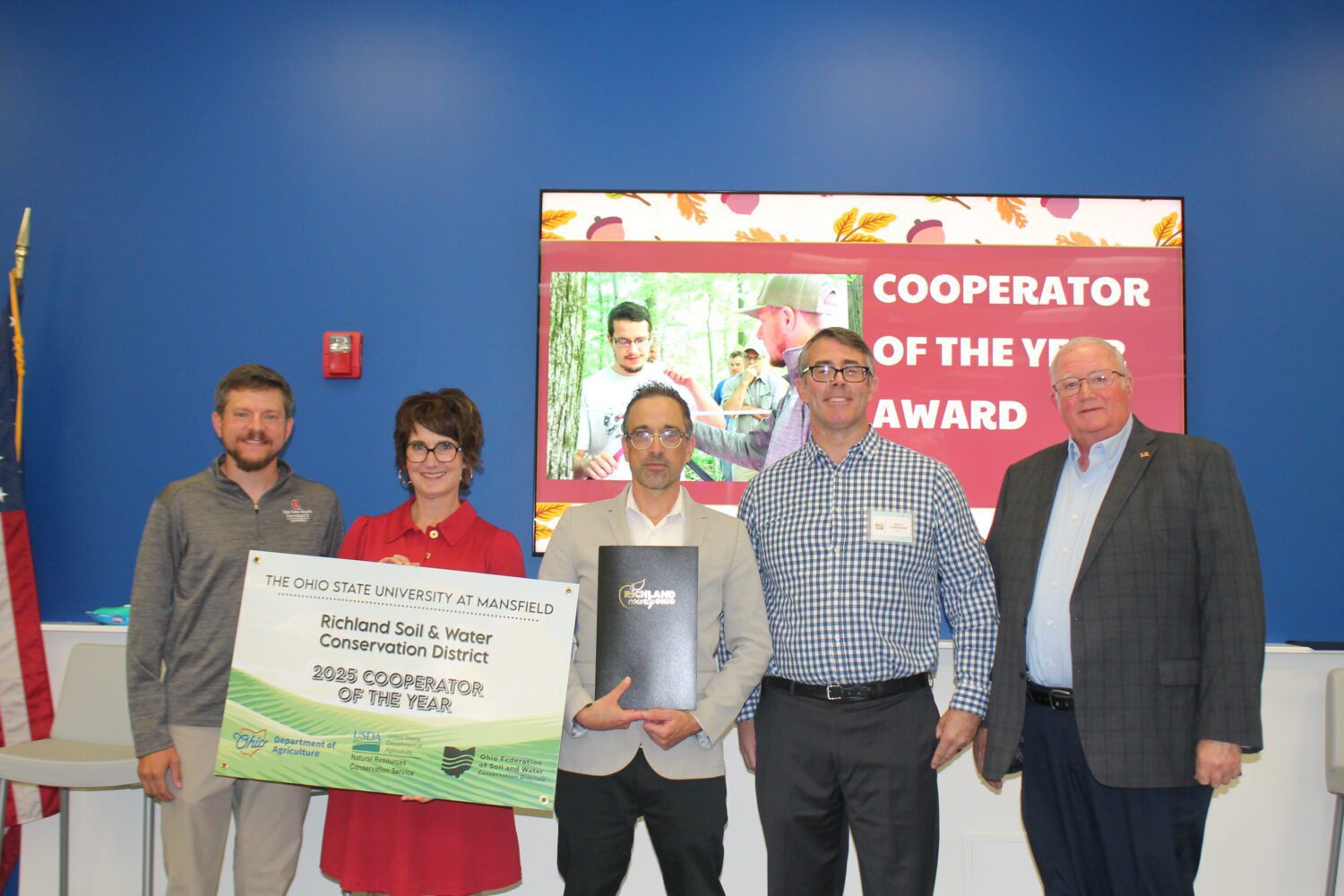 Gabe Karns, Cynthia Callahan, Dr. Jason Opal, Matt Christian and Commissioner Banks posed with the cooperator of the year award.