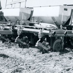 Seeder Farm Equipment with an unidentified man standing on top