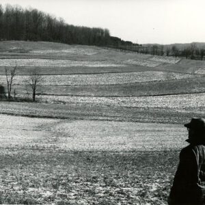 Man looking at a contour strip field.