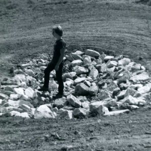 A man standing on a bowl-shaped expanse of rocks