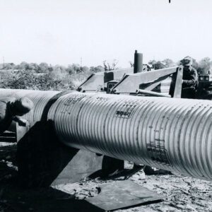 Men Installing Corrugated Drainage Pipe in a Farm Field