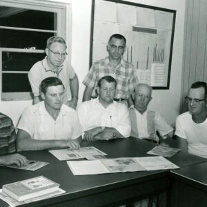 00_00_0000_Seven_men_at_table_examining_documents_2_Website-5809