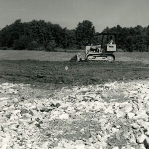 Front loader pushing dirt in a field