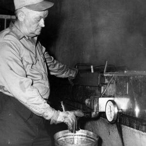 March 13, 1972 Robert Armstrong drawing off maple syrup.