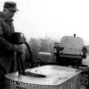March 12, 1976 Leo Fair pulls the pump from his sap-gathering tank.