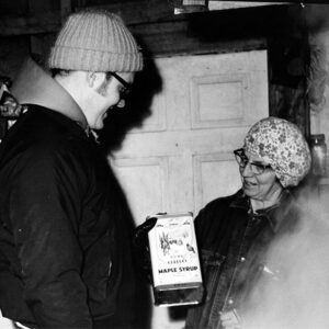 March 14, 1972 Forbes sugar house, Mrs. Randall Forbes Sr. with Norman Widman, maple sugar sales