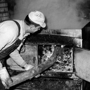 March 30, 1965 Dave Culler tending to wood stove