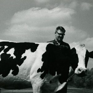May 11, 1966 Floyd McFarland Farm. Lonnie McFarland with a top-producing dairy cow.