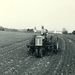 May 24, 1965. Man on a tractor in a field.