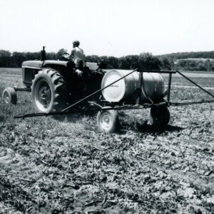 June 4, 1975. Man on a tractor applying liquid to a field