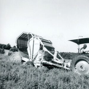 July 16, 1973 Lawrence Flenner on a Tractor with a Hay Baler
