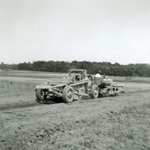 July 1961 Bill Rudrick on a bulldozer pulling a dirt pan