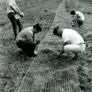 August 15, 1978 Unidentified men installing netting for a waterway