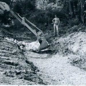 September 5, 1980 A contractor using unidentified equipment to place an oversized rip-rap along the sides for greater protection in the bottom of a waterway