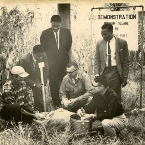 October 28, 1964 African visitors help check corn test plots at Putt Farm. Left to Right: Kenneth Putt, Hassein M. Bweiiti, B. Mioelondo, CA McGreu, Deming Seymour and AP Milunga.